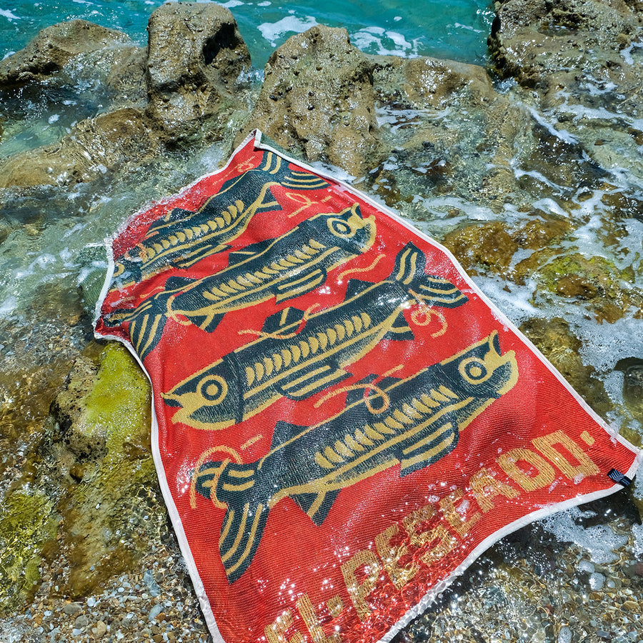 Stacked branded towels by the pool