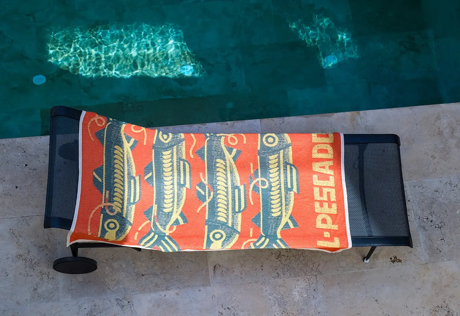 Custom beach towel draped over a sun lounger